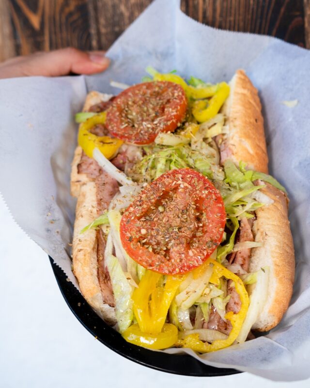 Philadelphia cheesesteak sandwich with melted cheese and grilled onions on Amoroso roll